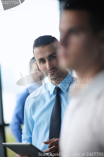 Image of business man using tablet compuer at office