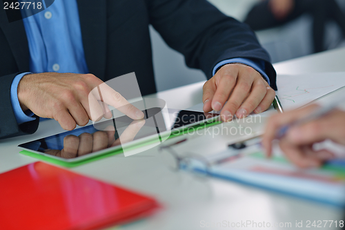 Image of business man using tablet compuer at office