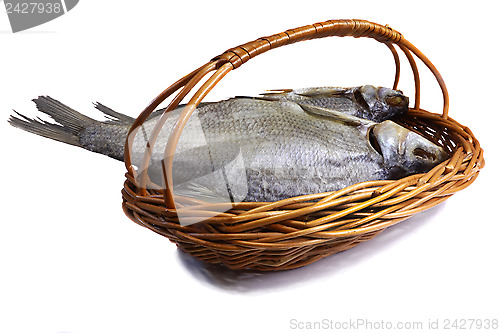 Image of Salted and dried fish river in a basket on a white background.