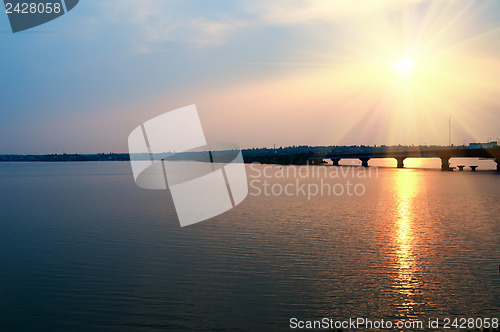 Image of sunset over river with bridge