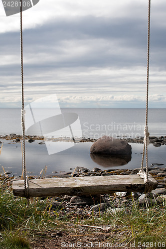 Image of wooden swing with ropes