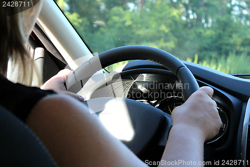 Image of Young woman driving the car