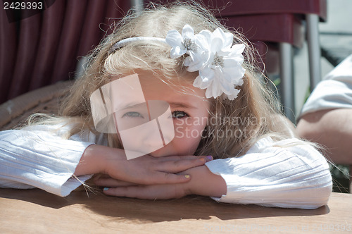 Image of Beautiful girl sitting on the table