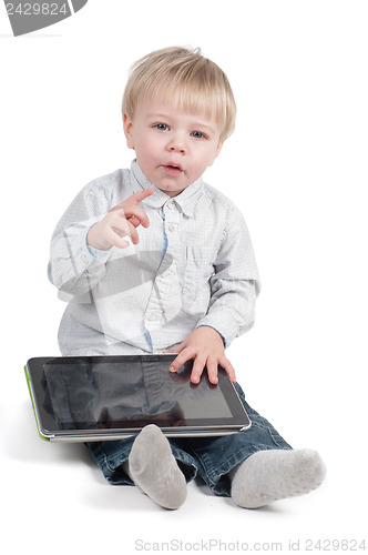 Image of Little cute boy sitting with tablet computer