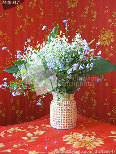Image of bouquet of lilies of the valley and blue flowers