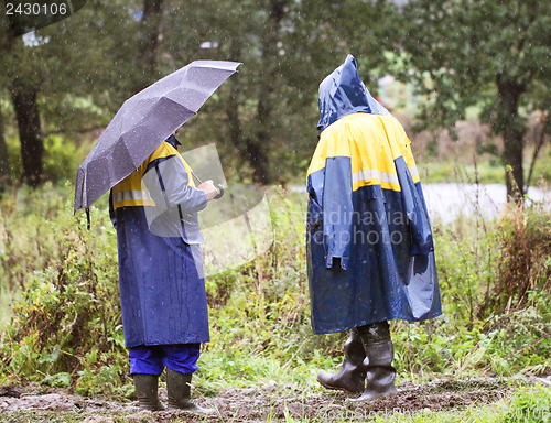 Image of Working going to rain on a muddy road