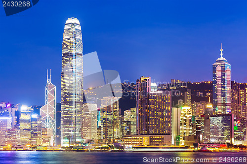 Image of Hong Kong city skyline at night with Victoria Harbor and skyscra