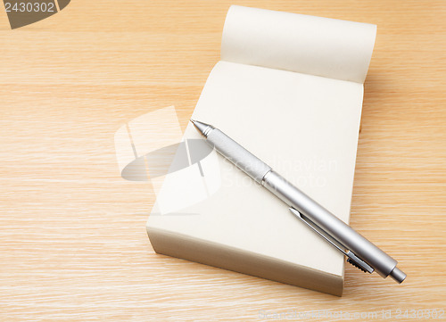 Image of Memo pad and pen on the table