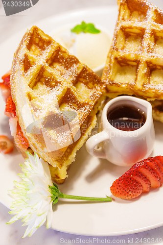 Image of Baked waffles with syrup and strawberries