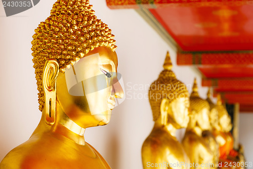 Image of Golden Buddha in a row