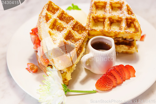 Image of Waffles with syrup and strawberries