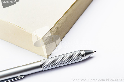 Image of Memo pad and pen close up