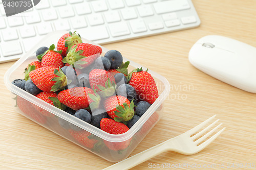 Image of Berry mix lunch box in working desk