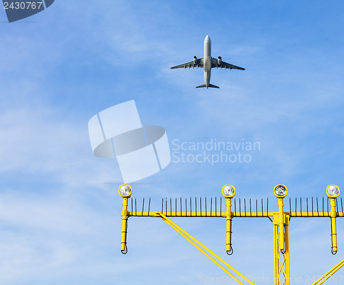 Image of Airport approach landing direction light with airplane