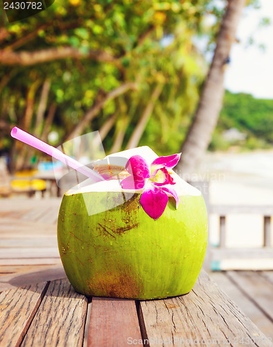 Image of Coconut drink on table beside beach