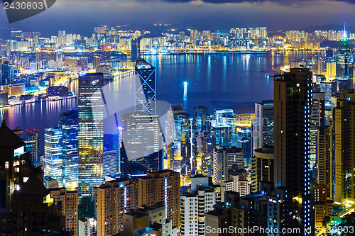 Image of Hong Kong city skyline at night with Victoria Harbor and skyscra