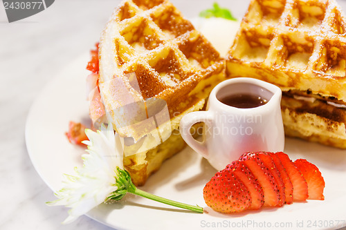 Image of Waffles with syrup and strawberries