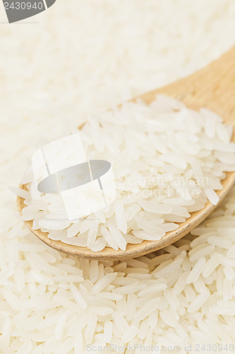 Image of Uncooked white rice on spoon