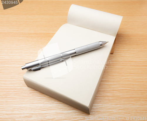 Image of Memo pad and pen on the table