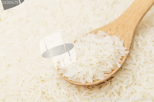 Image of Uncooked white rice with spoon