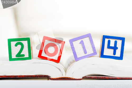 Image of Alphabet block with 2014 on book