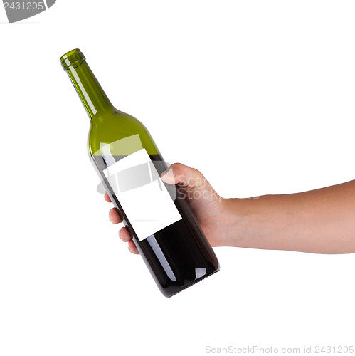 Image of Hand holding a bottle of red wine