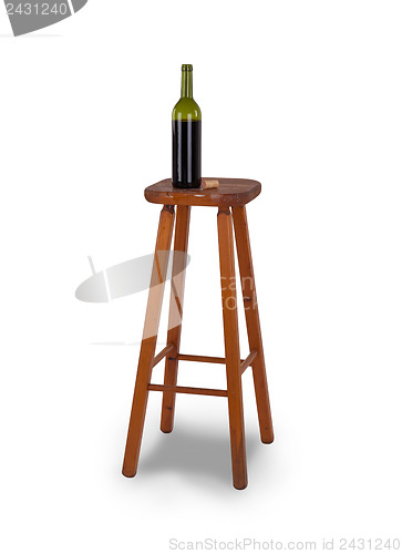 Image of Old stool and bottle of wine isolated