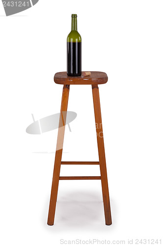 Image of Old stool and bottle of wine isolated