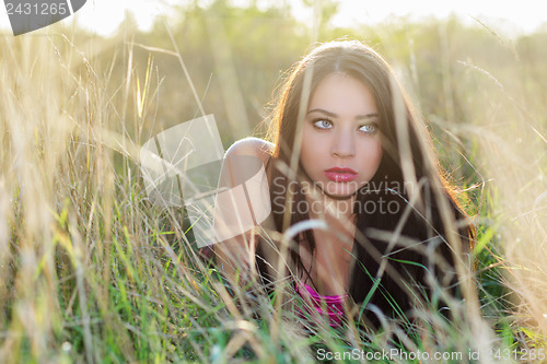 Image of Young brunette hiding