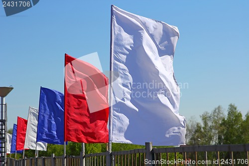 Image of colored flags on a blue sky background