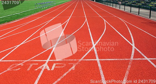 Image of Red treadmill at the stadium with white lines 