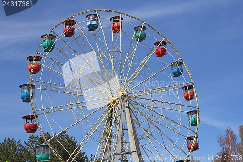 Image of Atraktsion colorful ferris wheel against the blue sky