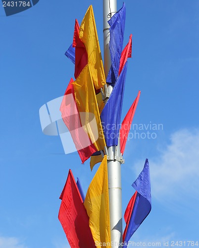 Image of colored flags on a blue sky background