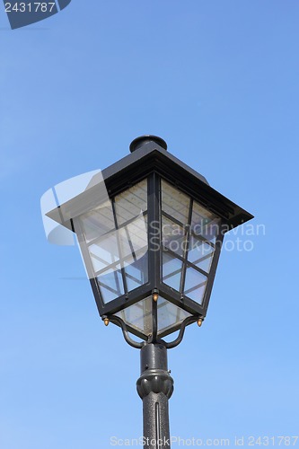 Image of street lamp against the background of blue sky