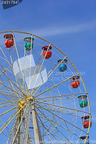 Image of Atraktsion colorful ferris wheel against the blue sky