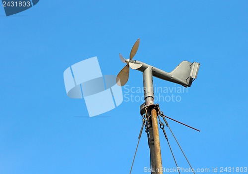 Image of Vintage wind mill the background of blue sky