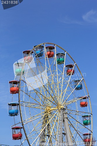 Image of Atraktsion colorful ferris wheel against the blue sky