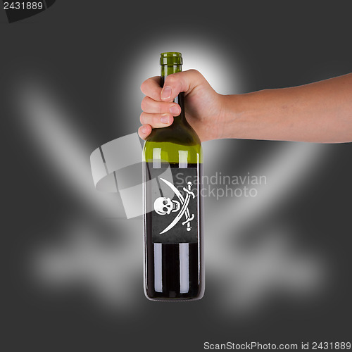 Image of Hand holding a bottle of red wine