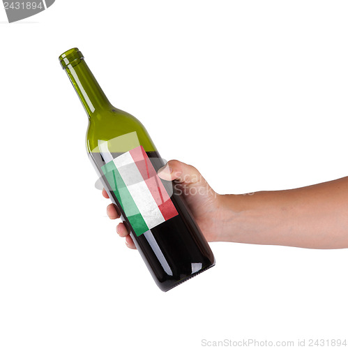 Image of Hand holding a bottle of red wine