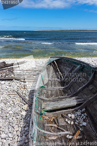 Image of Old wooden boat on the seashore