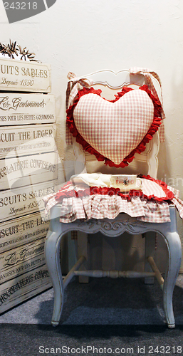 Image of Chair with a heart shaped pillow