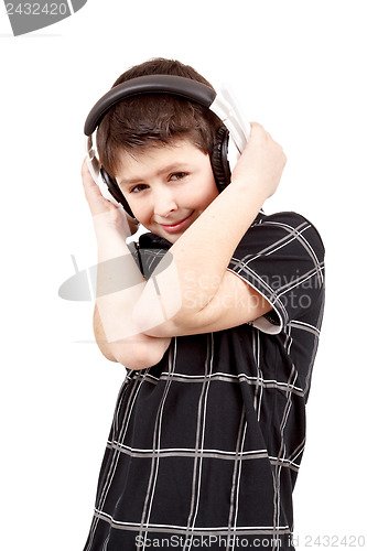 Image of Portrait of a happy smiling young boy listening to music on head