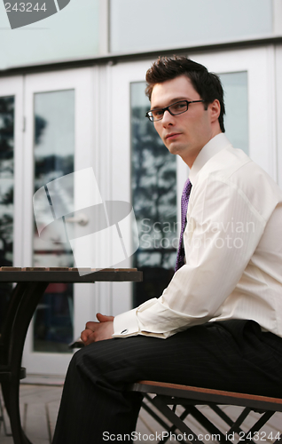 Image of Businessman sitting outside at a table