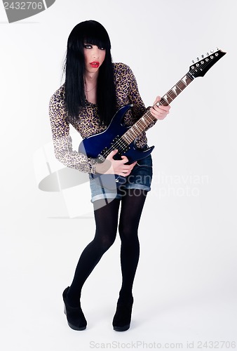 Image of transvestite in heels with electric guitar