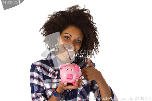 Image of Young african american woman with piggy bank