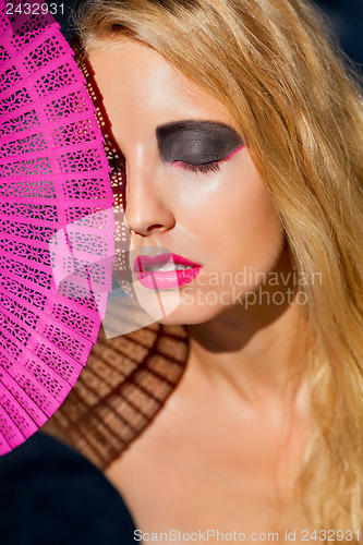 Image of young beautiful woman with smokey eyes and pink lips