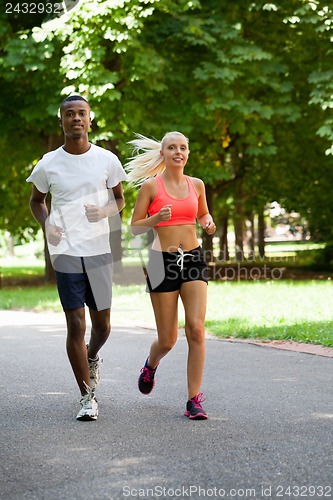 Image of young couple runner jogger in park outdoor summer