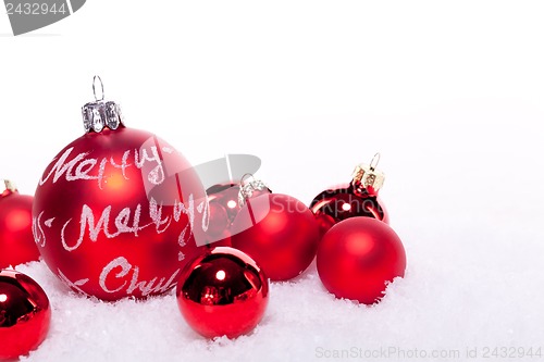 Image of christmas decoration festive red bauble in snow isolated