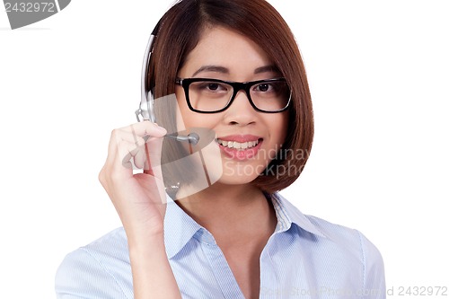 Image of young smiling asian businesswoman call center agent isolated
