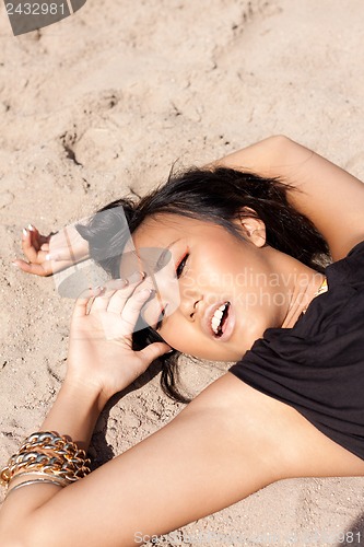 Image of beautiful asian woman with colorful makeup on the beach 